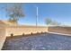 Large brick patio area is surrounded by a light-colored brick wall and sparse landscaping at 7256 Saxby Ave, Las Vegas, NV 89113