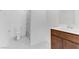This bathroom features a toilet, patterned shower curtain, and a dark wood vanity with a white sink at 7256 Saxby Ave, Las Vegas, NV 89113