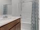 Bright bathroom features a white vanity with solid surface countertop and shower-over-tub combination at 7256 Saxby Ave, Las Vegas, NV 89113
