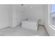 Contemporary bedroom features neutral carpet, white walls, a window, and a platform bed with integrated headboard at 7256 Saxby Ave, Las Vegas, NV 89113
