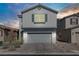 This two-story home has a grey exterior and grey garage door, along with a brick driveway at 7256 Saxby Ave, Las Vegas, NV 89113