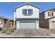 Charming two-story home with a gray stucco exterior, two car garage, and a well-maintained brick driveway at 7256 Saxby Ave, Las Vegas, NV 89113