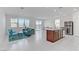 Open-concept living area with modern furnishings, white tile flooring, and lots of natural light at 7256 Saxby Ave, Las Vegas, NV 89113