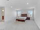 Expansive carpeted main bedroom with ensuite bathroom, large windows, and ample natural light at 7256 Saxby Ave, Las Vegas, NV 89113