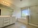 The bathroom boasts a soaking tub, vanity with sink, and glass-enclosed shower at 740 White Grotto St, Las Vegas, NV 89138