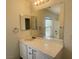 Updated bathroom with a vanity, mirror and lighting over a sink at 740 White Grotto St, Las Vegas, NV 89138