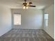 This bedroom features neutral walls, plush carpet and a ceiling fan at 740 White Grotto St, Las Vegas, NV 89138