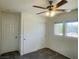 Carpeted bedroom with a closet, ceiling fan and neighborhood view at 740 White Grotto St, Las Vegas, NV 89138