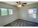 Carpeted bedroom featuring two windows, new carpet and a ceiling fan at 740 White Grotto St, Las Vegas, NV 89138