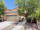 Inviting two-story home with a spacious two-car garage, manicured yard, and tiled roof at 740 White Grotto St, Las Vegas, NV 89138