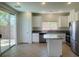 Open kitchen with granite countertops, stainless steel appliances, island, and access to outdoor patio at 740 White Grotto St, Las Vegas, NV 89138