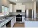Well-lit kitchen featuring granite countertops, stainless steel appliances, and ample cabinetry at 740 White Grotto St, Las Vegas, NV 89138