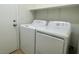 Bright laundry room featuring a white washer and dryer, with an added shelf for storage at 740 White Grotto St, Las Vegas, NV 89138