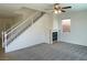 Spacious living room with a fireplace, stairs, and neutral carpet at 740 White Grotto St, Las Vegas, NV 89138
