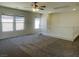 A well-lit, spacious loft area features neutral walls, plush carpet, and several large windows at 740 White Grotto St, Las Vegas, NV 89138