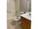 Clean bathroom with tiled floors, a shower-tub combo, wooden vanity, and ample lighting at 7614 Isley Ave, Las Vegas, NV 89147
