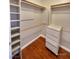 Walk-in closet with built-in shelving and drawers for organized storage at 7614 Isley Ave, Las Vegas, NV 89147