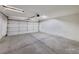 Spacious garage with concrete flooring and white door, offering ample parking and storage space at 7614 Isley Ave, Las Vegas, NV 89147
