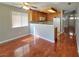 An open-concept dining area and kitchen with wood floors, cabinetry, and a view to the entrance at 7614 Isley Ave, Las Vegas, NV 89147