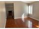 View from the dining area into the living room with wood flooring and a cozy fireplace at 7614 Isley Ave, Las Vegas, NV 89147