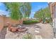 Private backyard featuring a beautiful stone water fountain and desert landscaping at 7645 Falconwing Ave, Las Vegas, NV 89131