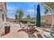 Outdoor patio area with comfortable seating, a shade umbrella, and landscaped yard at 7645 Falconwing Ave, Las Vegas, NV 89131