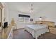 Bright bedroom featuring a large window, ceiling fan, and a spacious bed at 7645 Falconwing Ave, Las Vegas, NV 89131