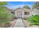 Inviting home entrance surrounded by drought resistant landscaping and a lighted walkway at 7645 Falconwing Ave, Las Vegas, NV 89131