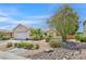 Well-maintained home with a two-car garage and mature landscaping in the front yard at 7645 Falconwing Ave, Las Vegas, NV 89131