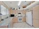 Bright kitchen features white appliances, and a decorative shelf for displaying decorative items at 7645 Falconwing Ave, Las Vegas, NV 89131