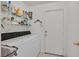 Functional laundry room with washer, dryer, shelving, and outside access door at 7645 Falconwing Ave, Las Vegas, NV 89131