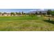 Expansive golf course view with players, sand traps, and desert landscaping, a golfer's dream at 7649 Broadwing Dr, North Las Vegas, NV 89084