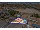 Aerial view of home with desert landscaping, solar panels, and swimming pool at 7668 Friendly Breeze Ct, Las Vegas, NV 89123