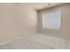 Bright bedroom with neutral carpet and a large window at 7668 Friendly Breeze Ct, Las Vegas, NV 89123