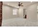 Spacious bedroom with plush carpet, a ceiling fan, and neutral paint for a serene, comfortable atmosphere at 7668 Friendly Breeze Ct, Las Vegas, NV 89123