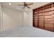 Bedroom boasts plush carpeting, a built-in bookcase, and neutral walls for a cozy, inviting space at 7668 Friendly Breeze Ct, Las Vegas, NV 89123
