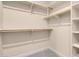 Walk-in closet featuring carpet flooring, white shelving, and chrome rod racks for optimized storage and organization at 7668 Friendly Breeze Ct, Las Vegas, NV 89123