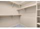 Walk-in closet features carpet flooring, white shelving, and chrome rod racks for optimized storage and organization at 7668 Friendly Breeze Ct, Las Vegas, NV 89123