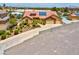 Expansive home with tiled roof, desert landscaping, three car garage, and long driveway at 7668 Friendly Breeze Ct, Las Vegas, NV 89123
