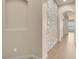 Elegant hallway with stone accent wall and tile flooring throughout at 7668 Friendly Breeze Ct, Las Vegas, NV 89123