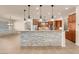 Gourmet kitchen featuring granite countertops, pendant lighting, stainless appliances, and custom cabinetry at 7668 Friendly Breeze Ct, Las Vegas, NV 89123