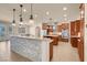 Gourmet kitchen featuring granite countertops, pendant lighting, stainless appliances, and custom cabinetry at 7668 Friendly Breeze Ct, Las Vegas, NV 89123