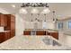 Gourmet kitchen featuring granite countertops, pendant lighting, stainless appliances, and custom cabinetry at 7668 Friendly Breeze Ct, Las Vegas, NV 89123