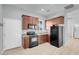 Kitchen with brown cabinets and black appliances at 7668 Friendly Breeze Ct, Las Vegas, NV 89123