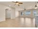 Open-concept living room with tile flooring, windows with great view and modern ceiling fan at 7668 Friendly Breeze Ct, Las Vegas, NV 89123