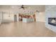 Large open-concept living area with modern kitchen, fireplace and neutral decor at 7668 Friendly Breeze Ct, Las Vegas, NV 89123
