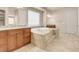 Elegant bathroom features a large tub, neutral tiles, and walk-in closet at 7668 Friendly Breeze Ct, Las Vegas, NV 89123