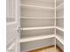 Walk-in pantry with custom shelving and tile flooring provides ample storage for all your kitchen needs at 7668 Friendly Breeze Ct, Las Vegas, NV 89123