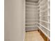 Walk-in pantry with custom shelving and tile flooring provides ample storage for all your kitchen needs at 7668 Friendly Breeze Ct, Las Vegas, NV 89123