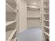 Large walk-in closet with built-in shelving units and a neutral carpet at 7668 Friendly Breeze Ct, Las Vegas, NV 89123